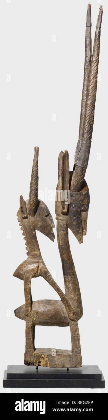 A Bambara chi-wara dance headpiece,Burkina Faso,1st half of the 20th century. A wooden figure of two antelopes carved in several pieces. Light patina with remnants of a dark coloured finish along with some iron nails. Leather sleeves over the attached horns of the male figure,the points are also wrapped with leather. Beautiful condition with traces of age and use. Height(without base)105 cm. Provenance: W. van de Ven Collection,Netherlands. historic,historical,fine arts,art,tribe,tribes,tribal,African,Africa,ethnical,ethnicities,ethnology,ethn,Additional-Rights-Clearences-Not Available Stock Photo