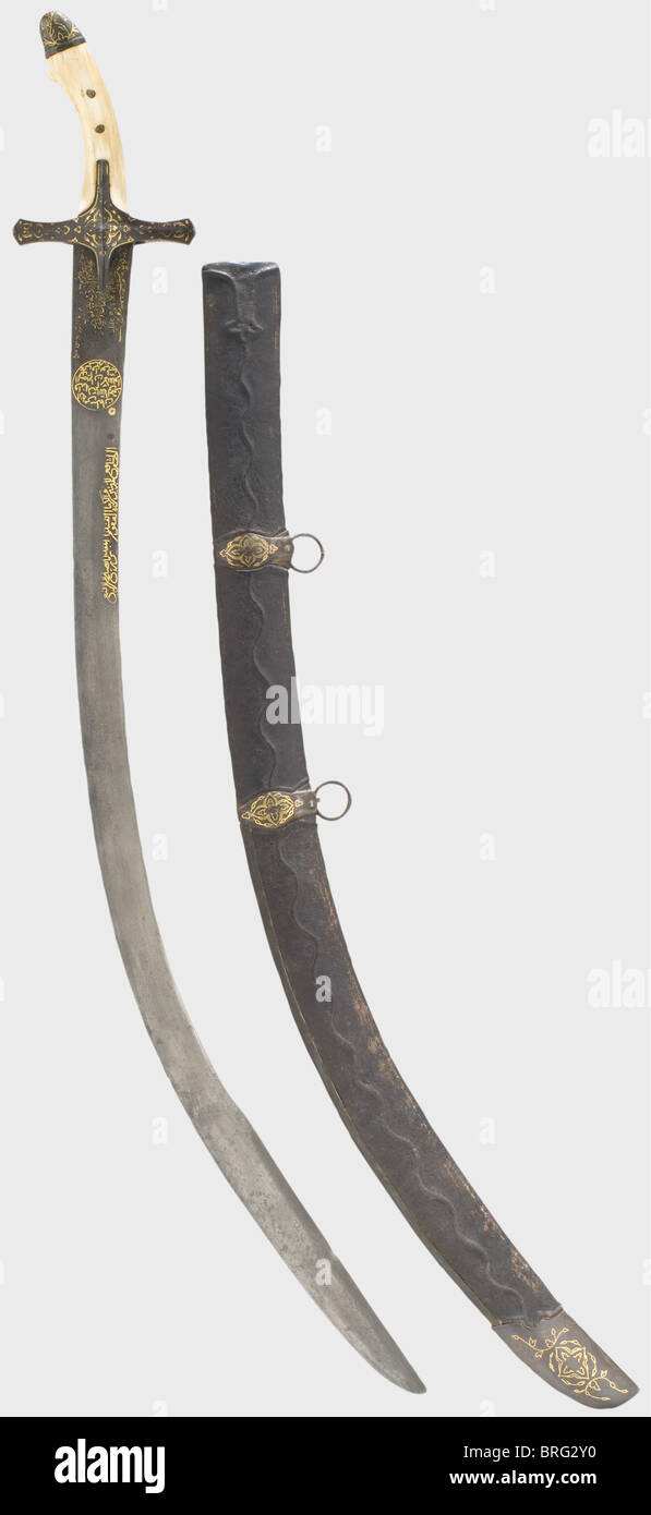 A gold-inlaid Ottoman kilij,1st half of the 17th century. Curved single-edged Damascus blade,with a broad double-edged point. A worn,gold-inlaid inscription on the obverse side of the ricasso,followed by two gold-inlaid inscription cartouches. Iron quillons(16th cent.)with(worn)gold inlay. Replacement ivory grip and gold-inlaid iron pommel cap. Later,leather-covered,wooden scabbard with gold-inlaid iron mountings. Length 91 cm. historic,historical,,17th century,Ottoman Empire,thrusting,thrustings,hand weapon,hand weapons,melee weapon,melee we,Additional-Rights-Clearences-Not Available Stock Photo