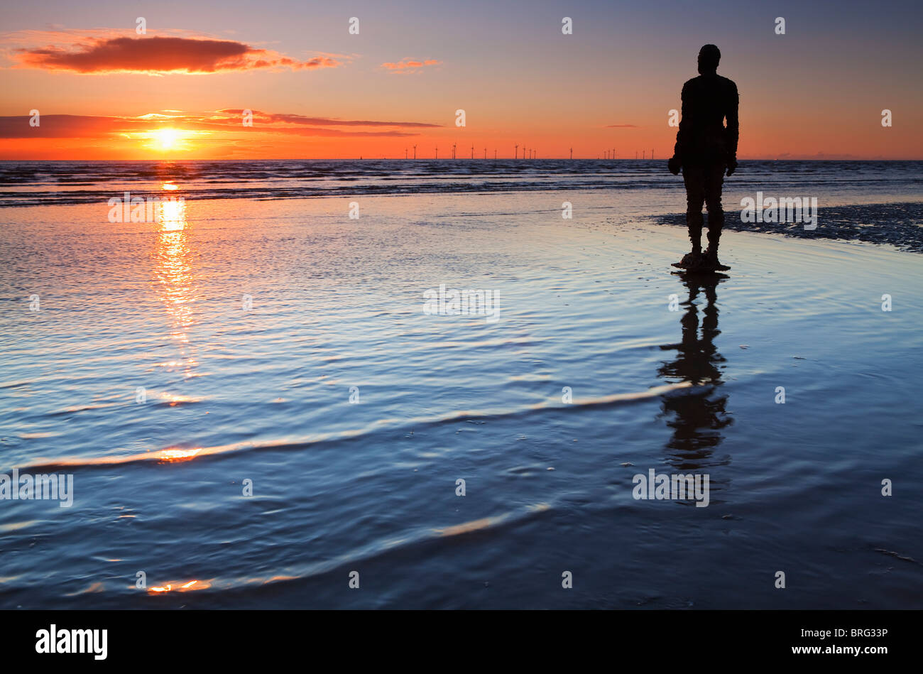 Horizontal photograph of Anthony Gormley's Another Place Sculpture, Crosby Stock Photo