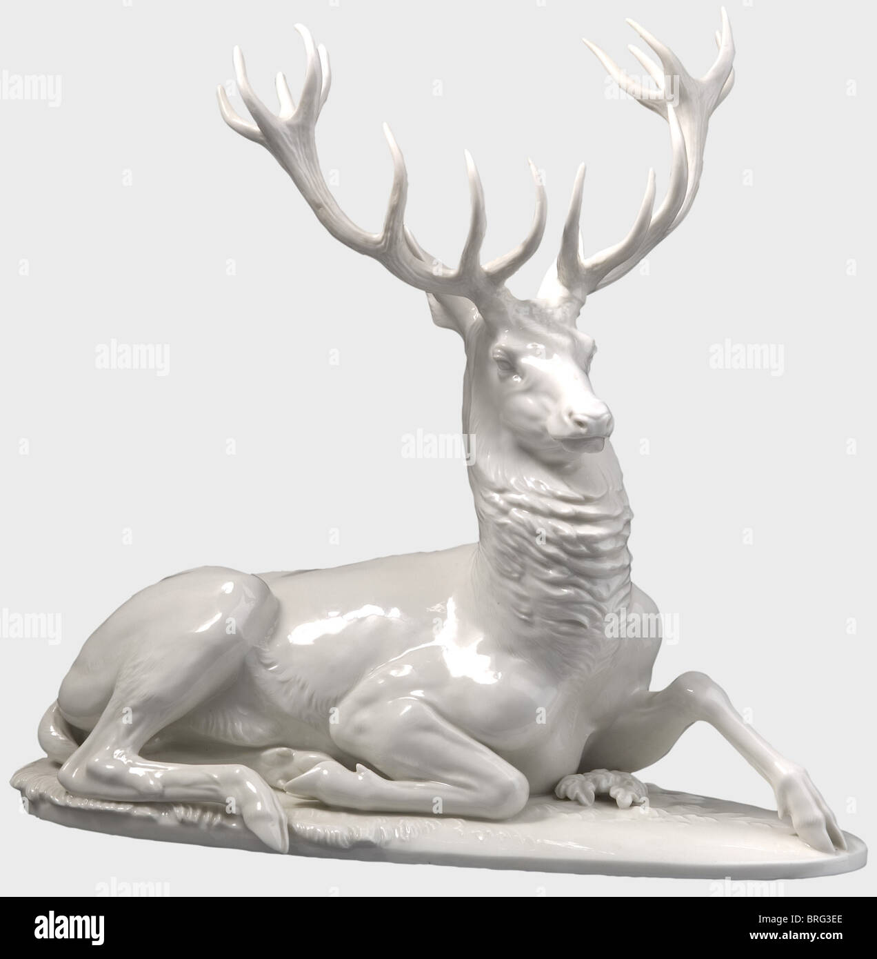 A recumbent stag., White glazed porcelain figure, separate inset antlers, and with the model number '60', the Allach press mark in the octagon, and 'Prof. Th. Kärner' on the bottom. Ears and antlers restored. Height 35 cm. historic, historical, 1930s, 1930s, 20th century, object, objects, stills, clipping, clippings, cut out, cut-out, cut-outs, Additional-Rights-Clearences-Not Available Stock Photo