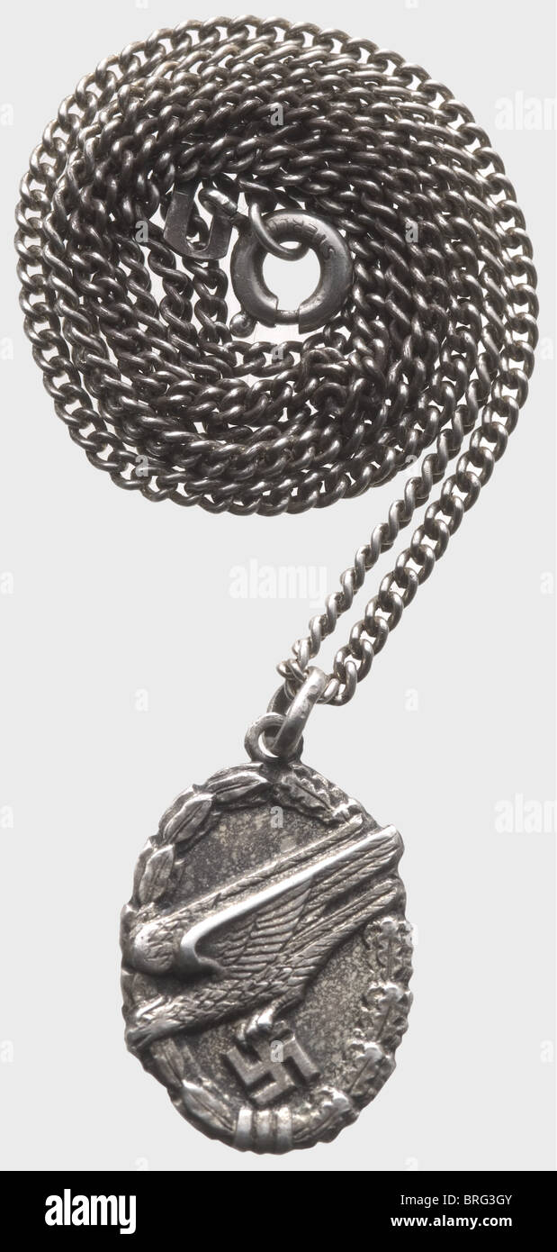 A Paratroop Loyalty Medallion.,Finely struck medallion with depiction in relief of the Paratrooper's Badge,reverse with inscription 'Treue um Treue'(Loyalty for Loyalty),'800' mark of fineness and Milanese(?)jeweller's punch mark.Diameter 20 x 14 mm.Silver carrying chain,the closure stamped 'Sterling'.Total weight 5.5 g.Abbot Gregorio Diamare among others presented a small silver token in gratitude for the preservation of the art treasures in Monte Cassino monastery before the American bombardment.This was the origin of the loyalty medallions,togeth,Additional-Rights-Clearences-Not Available Stock Photo