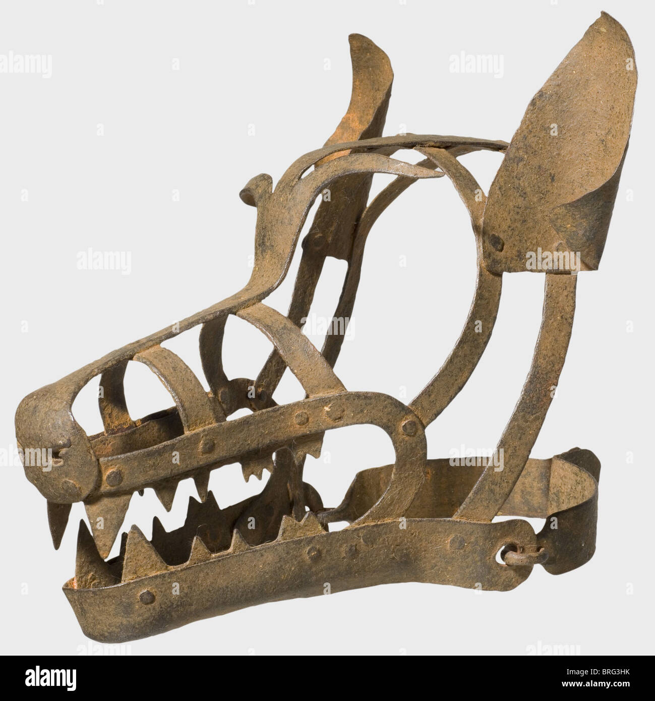 A German mask of disgrace in the shape of a wolf's head,16th/17th century. Forged iron. A mask made from riveted bar stock with pronounced teeth and ears attached by rivets. Two piece,hinged neckband. At the nape of the neck loops for a padlock. Length 40 cm. A mask of disgrace in the shape of a wolf's head was placed on those pilloried for deeds of violence. historic,historical,,17th century,16th century,instrument of torture,torture device,instruments of torture,torture devices,object,objects,stills,clipping,clippings,cut out,cut-out,cut-outs,Additional-Rights-Clearences-Not Available Stock Photo