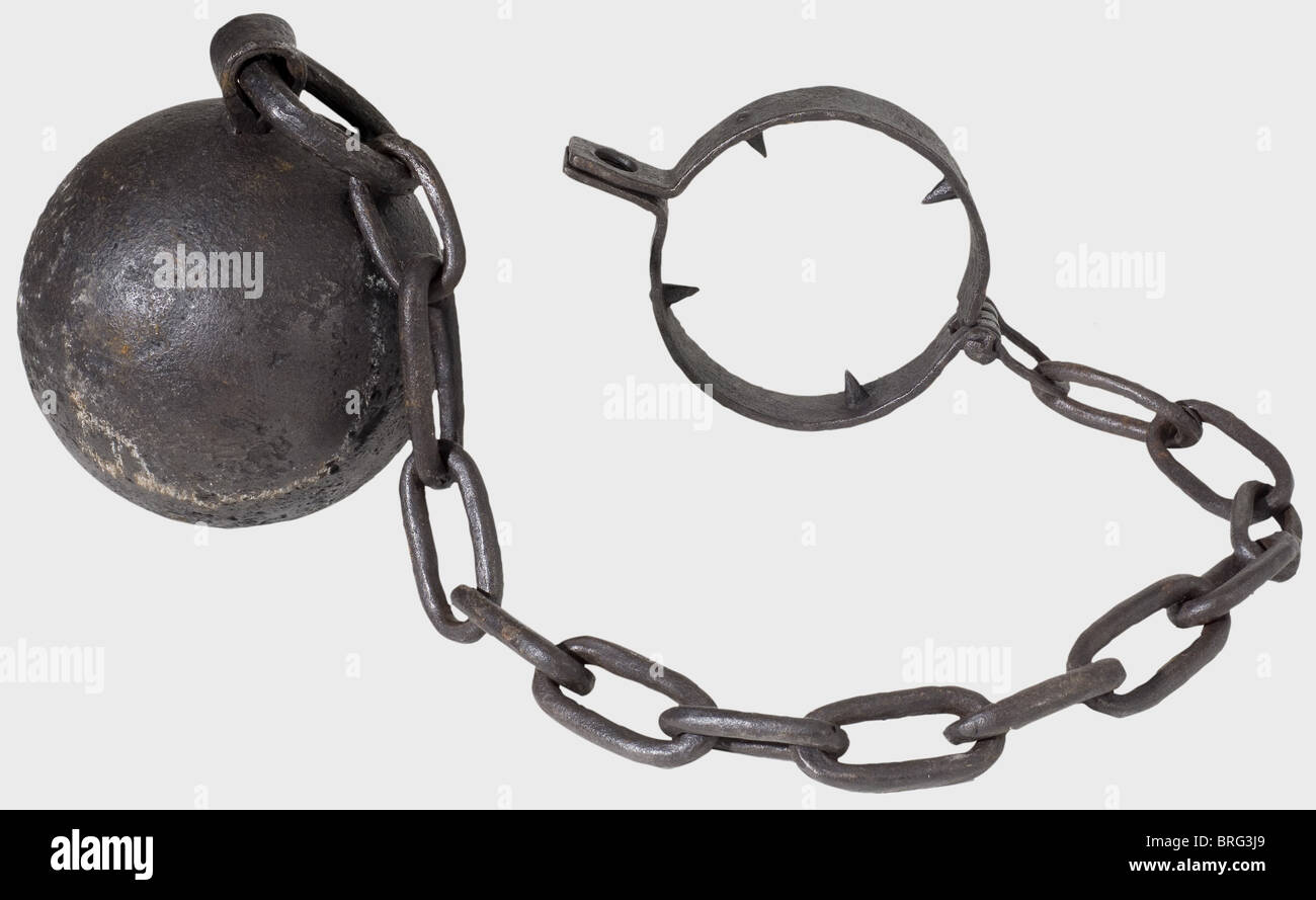 A German heavy ball and chain, 16th/17th century. Forged iron. Heavy, hinged neck ring with two loops for a padlock. The interior is fitted with four heavy quadrangular spikes. It is attached to a large iron ball by a heavy forged chain. Length 170 cm. Ball diameter 23 cm. historic, historical,, 17th century, 16th century, instrument of torture, torture device, instruments of torture, torture devices, object, objects, stills, clipping, clippings, cut out, cut-out, cut-outs, Additional-Rights-Clearences-Not Available Stock Photo