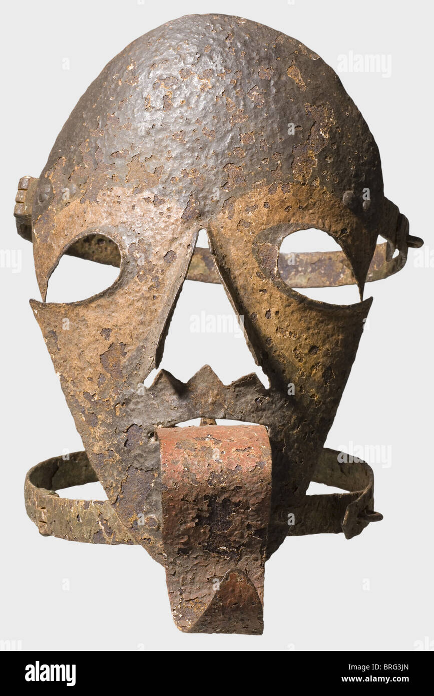 A German mask of disgrace,16th/17th century.Forged iron with remnants of  colour finish.Iron faceplate with openings for eyes,mouth,and nose.Riveted  tongue sticking far out with a large spiked mouth plate on the other  end.Riveted,hinged
