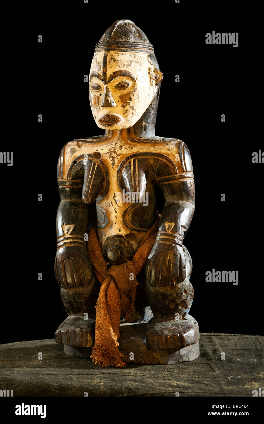 African full body female statue wooden carving Idol / deity / god. painted white face and body. Stock Photo