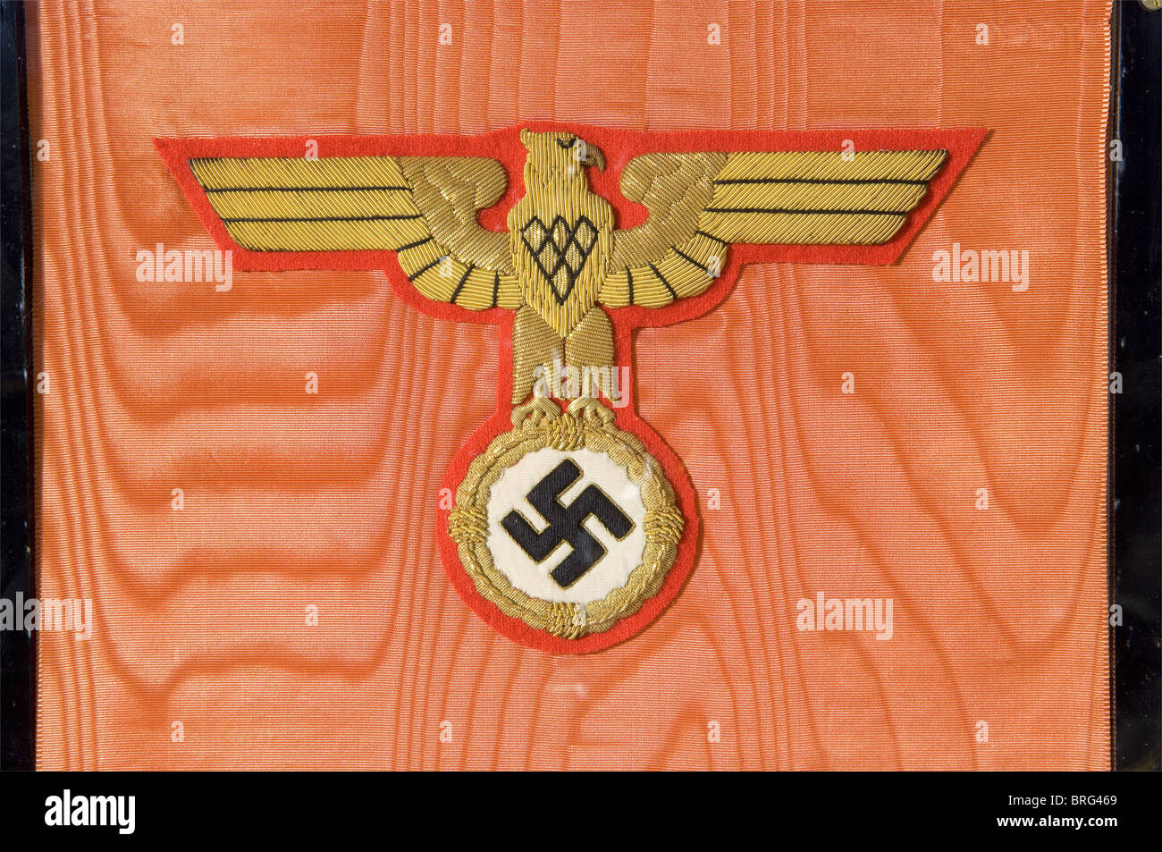 Adolf Hitler - a wreath ribbon for the funeral ceremonies for Reinhard Heydrich,on 9 June 1942 at the Mosaic Hall of the New Reich's Chancellery in Berlin.Red,watered ribbed silk with Hitler's personal heraldic eagle embroidered in gold over the stamped gold inscription.'Der Führer und Oberste Befehlhaber der Wehrmacht'(The Führer and Supreme Commander of the Wehrmacht).The opposite side displays Hitler's personal standard as supreme commander of the Wehrmacht embroidered in gold on silk.A gold fringe along the lower edge.Length ca.110 cm.Outstanding ,Additional-Rights-Clearences-Not Available Stock Photo