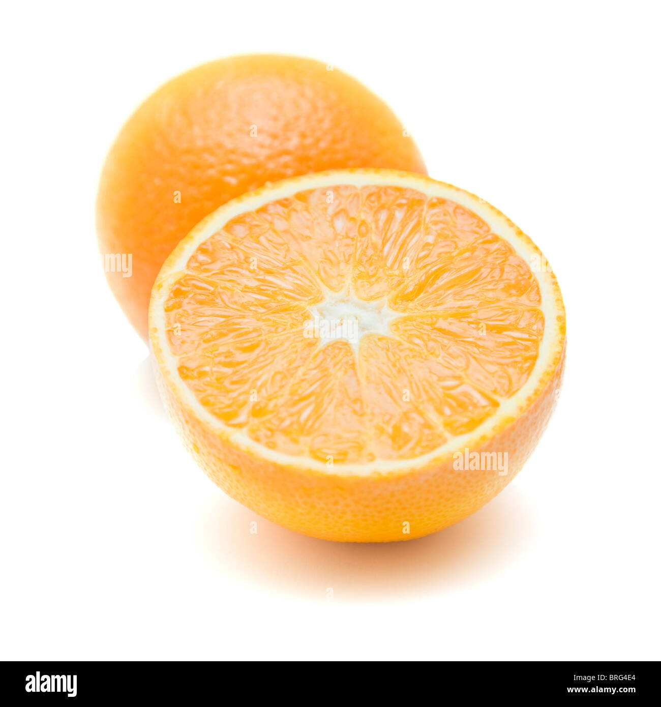 whole orange and ornage cut in half; isolated on white; Stock Photo