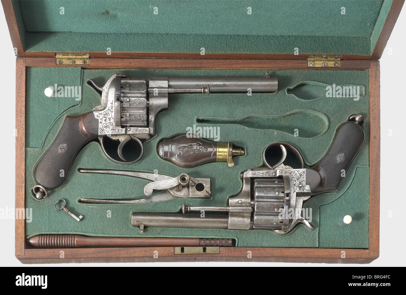 A cased pair of ten-shot pin-fire revolvers,Liège,circa 1870. 11 mm Lefaucheux calibre. Serial numbers 107790 and 110566. Slightly different revolvers with ten-shot cylinders. Frames and cylinders are engraved with grape leaf decoration. Walnut grip panels with fine checkering. Lanyard rings. Length of each 29 cm. In a later(?)case lined with green felt,also containing powder flask,bullet mould,and cleaning rod. Lockable. Key present. Case dimensions 43 x 24 x 9,5 cm. Erwerbsscheinpflichtig. historic,historical,19th century,civil handgun,civil handgun,Additional-Rights-Clearences-Not Available Stock Photo