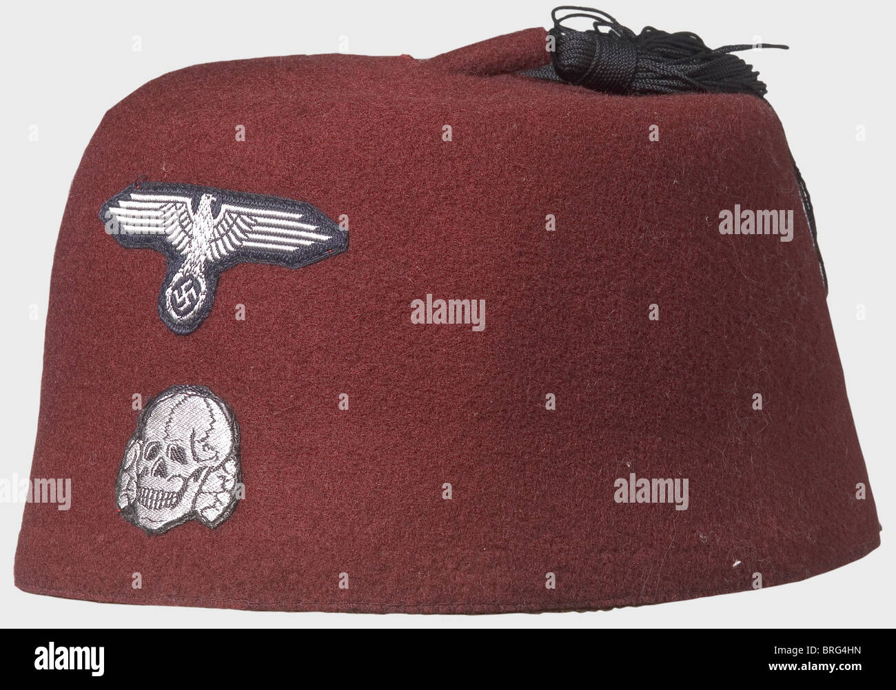 A fez for the dress uniform, for a Moslem Unit. Red felt with a black silk tassel and machine sewn BeVo insignia (silver-grey on black backing). Leather sweatband. historic, historical, 1930s, 20th century, Waffen-SS, armed division of the SS, armed service, armed services, NS, National Socialism, Nazism, Third Reich, German Reich, Germany, military, militaria, utensil, piece of equipment, utensils, object, objects, stills, clipping, clippings, cut out, cut-out, cut-outs, fascism, fascistic, National Socialist, Nazi, Nazi period, Additional-Rights-Clearences-Not Available Stock Photo
