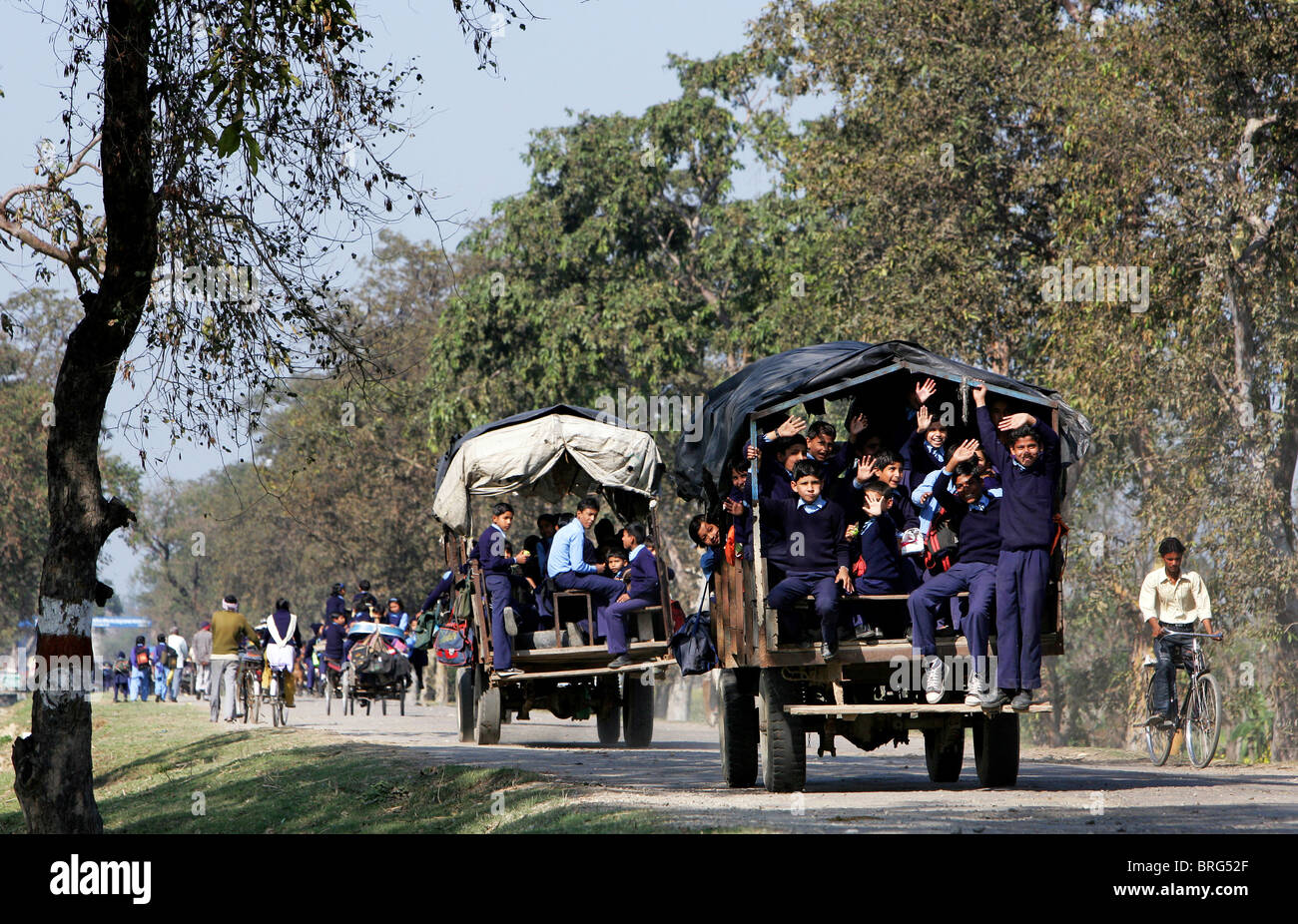 Schoolchildren riding home from school using an old tractor. Uttar Pradesh, India Stock Photo