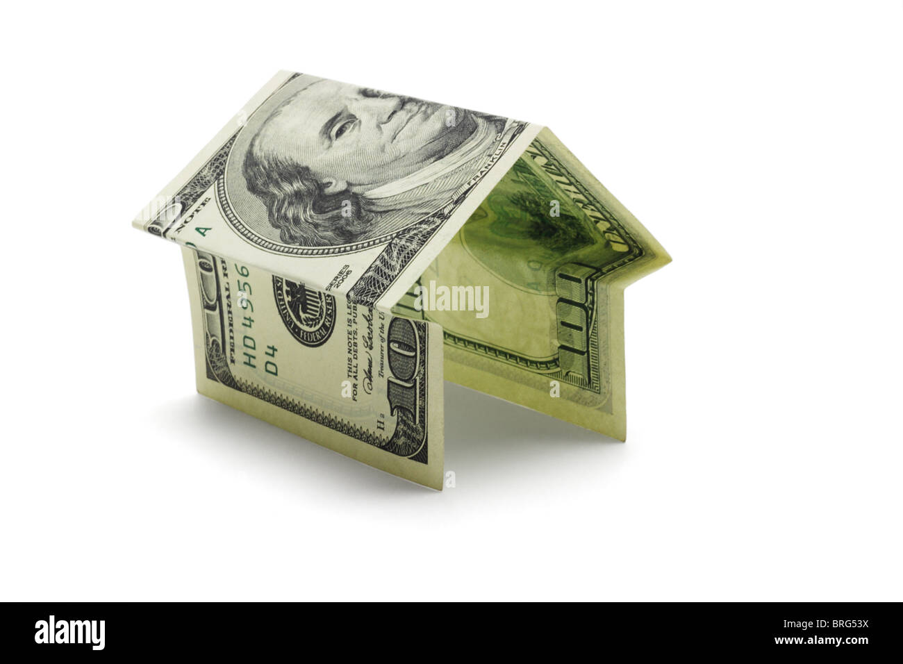 100 US dollars bill folded into shape of house on white background Stock Photo