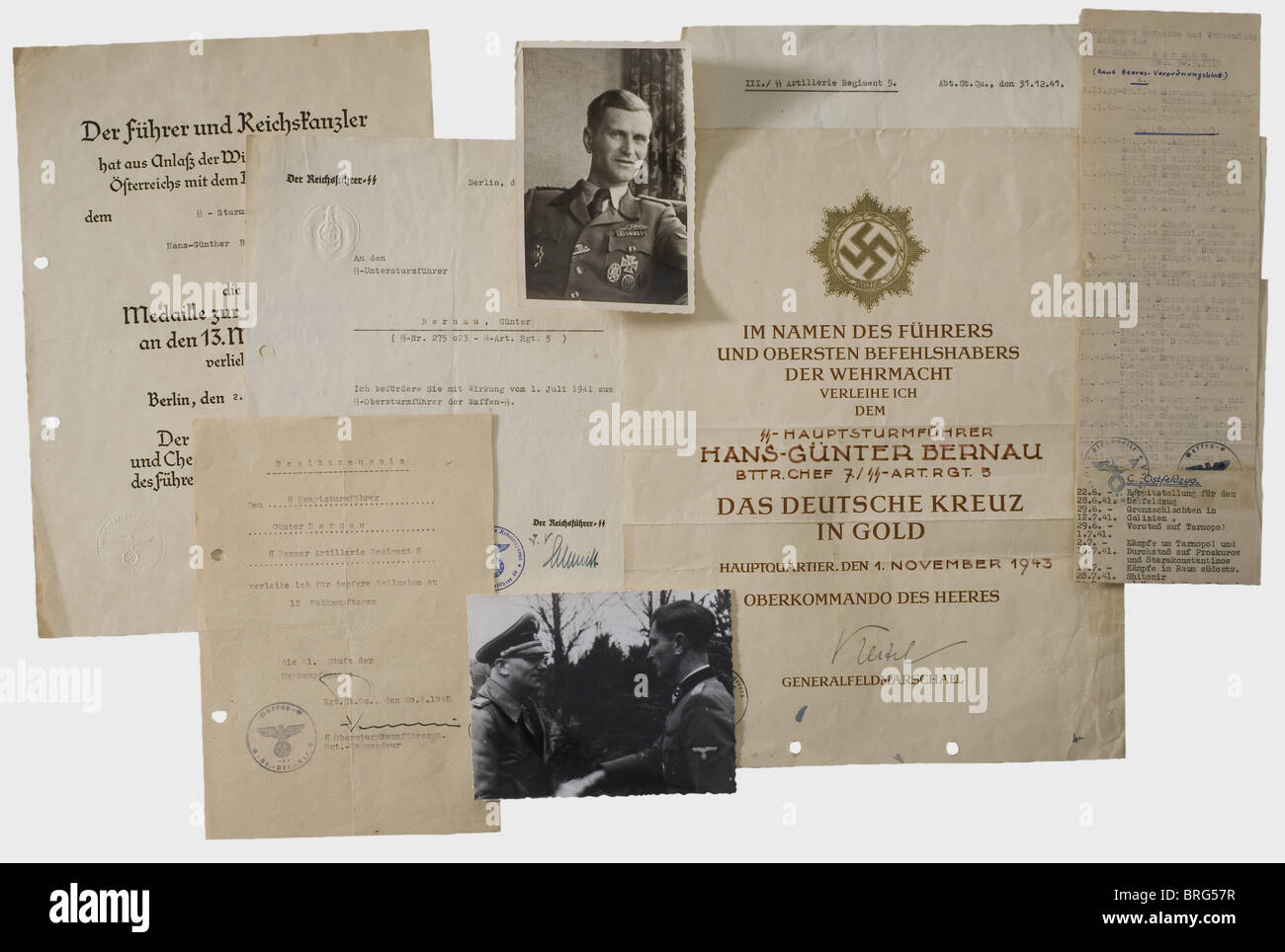 SS-Sturmbannführer Hans-Günther Bernau, award certificates and documents Large, elaborate award document for the German Cross in Gold dated 1 November 1943 as battery commander 7th/SS Artillery Regiment 5 with ink signature of Keitel. Holed, folded and trimmed to ca. 32 x 25 cm size. Award list and a photograph of the award ceremony with SS Major General Gille are included. Typewritten preliminary award notification document for the Close Combat Clasp Grade I for 15 combat days dated 20 April 1945. Award document for the Commemorative Medal of 13 March 1938 dat, Stock Photo