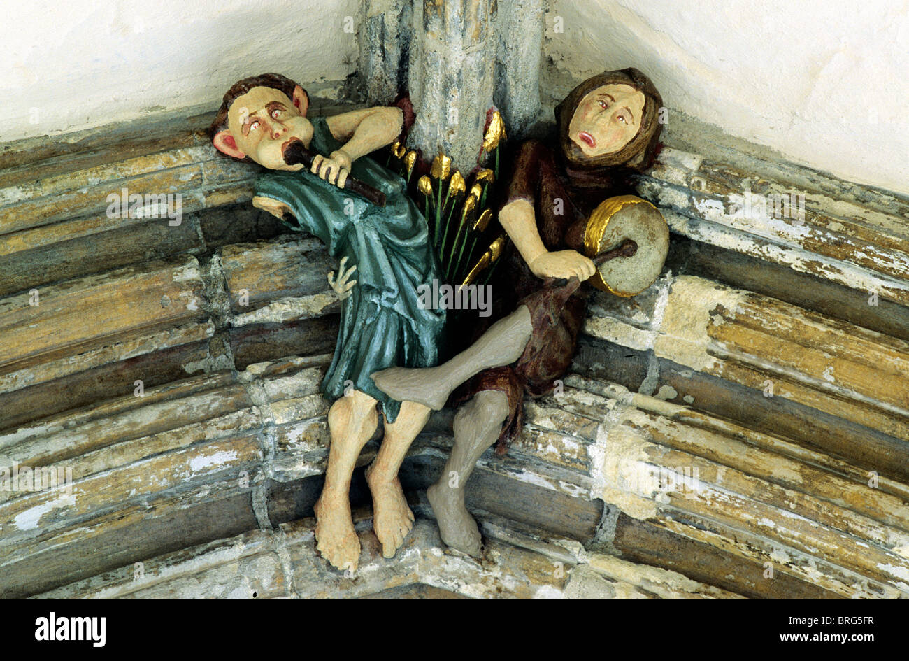 Norwich Cathedral Cloisters, roof boss, medieval musicians minstrels music bosses figure figures painted stone carving carvings Stock Photo