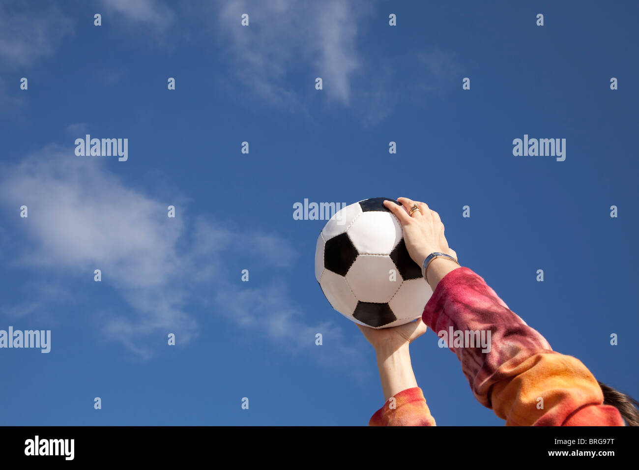 Hands holding a soccer ball up to the sky Stock Photo Alamy