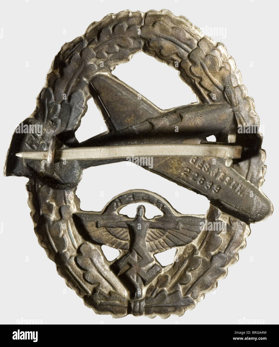 A NSFK Badge for Powered Aircraft Pilot,2nd issue after 1939 Silver-plated non-ferrous metal,hollow-stamped,the reverse marked 'Ges Gesch 22638',flat nickel silver pin attachment(OEK 3673). The badge introduced on 1 May 1939 superseded the earlier,silver-embroidered cloth issue badge and,as Christiansen wished,it bore the NSFK emblem instead of the swastika.,historic,historical,1930s,20th century,awards,award,German Reich,Third Reich,Nazi era,National Socialism,object,objects,stills,medal,decoration,medals,decorations,clipping,cut out,Additional-Rights-Clearences-Not Available Stock Photo