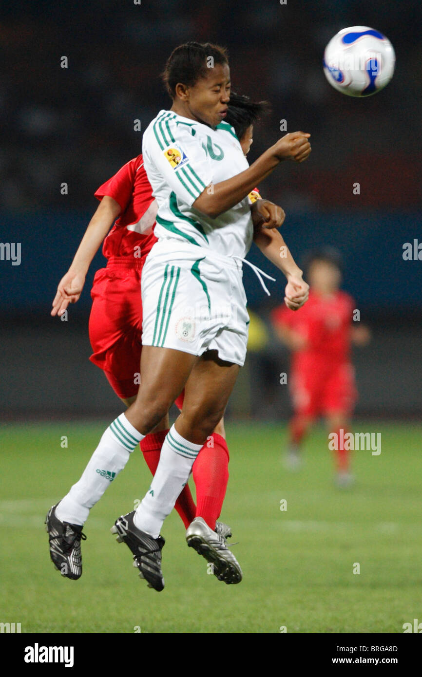 Ulunma Jerome of Nigerian jumps for a header against the Korea DPR during a 2007 Women's World Cup soccer match. Stock Photo