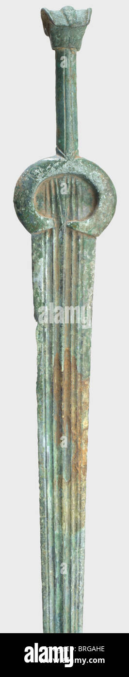 A bronze sword,Urartian/New Hittite,8./7.century B.C.Bronze with emerald  green patina.Double-edged blade with fine ridges and fullers on both  sides.There are three concentric circle decorations on each of the  clamp-like hilt bases.Slightly tapered ...