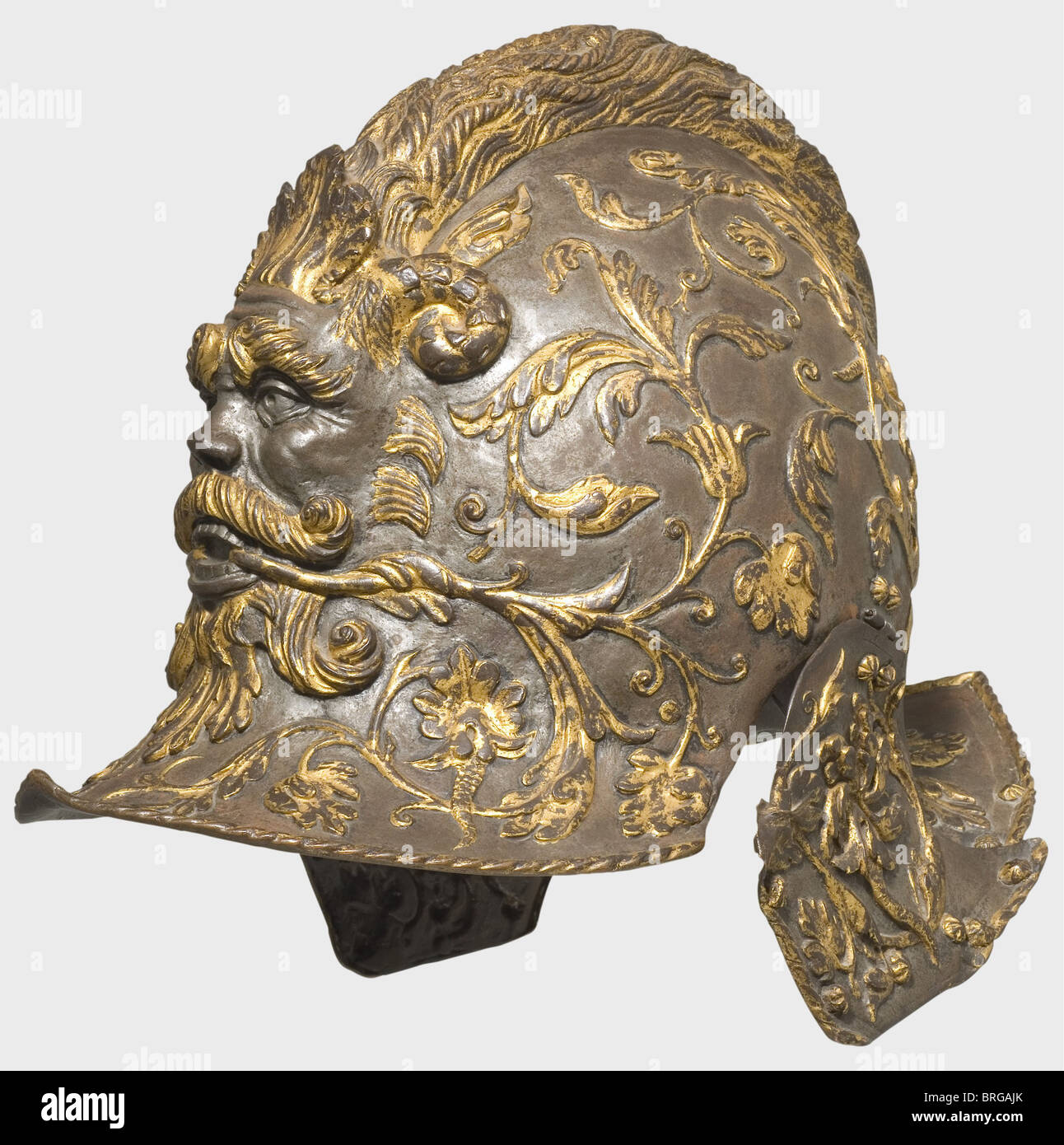 A burgonet of Henry II of France(1519 - 1559),end of the 19th century Copper electroplating with finely worked surface and fire gilding. Grotesque mask on the front in the shape of a horned man's head,with acanthus vines and flowers growing out of his mouth,elegantly emphasised by the dark background. The comb is in the shape of a hair braid. Height 26.5 cm. The original is to be found in the Musée du Louvre,Paris(MR.R.3)and was made by Giovan Paolo Megroli in Milan,circa 1545. The matching armour is in private hands(Hever Castle Auction,London,5 May,Additional-Rights-Clearences-Not Available Stock Photo