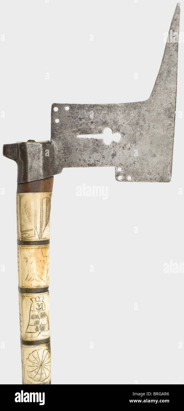 A Saxon miner's axe,dated 1683 Openwork iron blade. Walnut helve completely covered with engraved and blackened bone. Christ's head is displayed on the back of the helve with the inscriptions 'INRI' and the monogram 'HNH'. Grip plate has crossed miner's hammers between the date '1683' and the Saxon coat of arms. Length 85 cm.,historic,historical,,17th century,axe,ax,axes,ax,tool,tools,military,militaria,fighting device,object,objects,stills,battle ax,battle axe,poleaxe,battle axes,battle axes,poleaxes,clipping,cut out,cut-out,cut-outs,,Additional-Rights-Clearences-Not Available Stock Photo