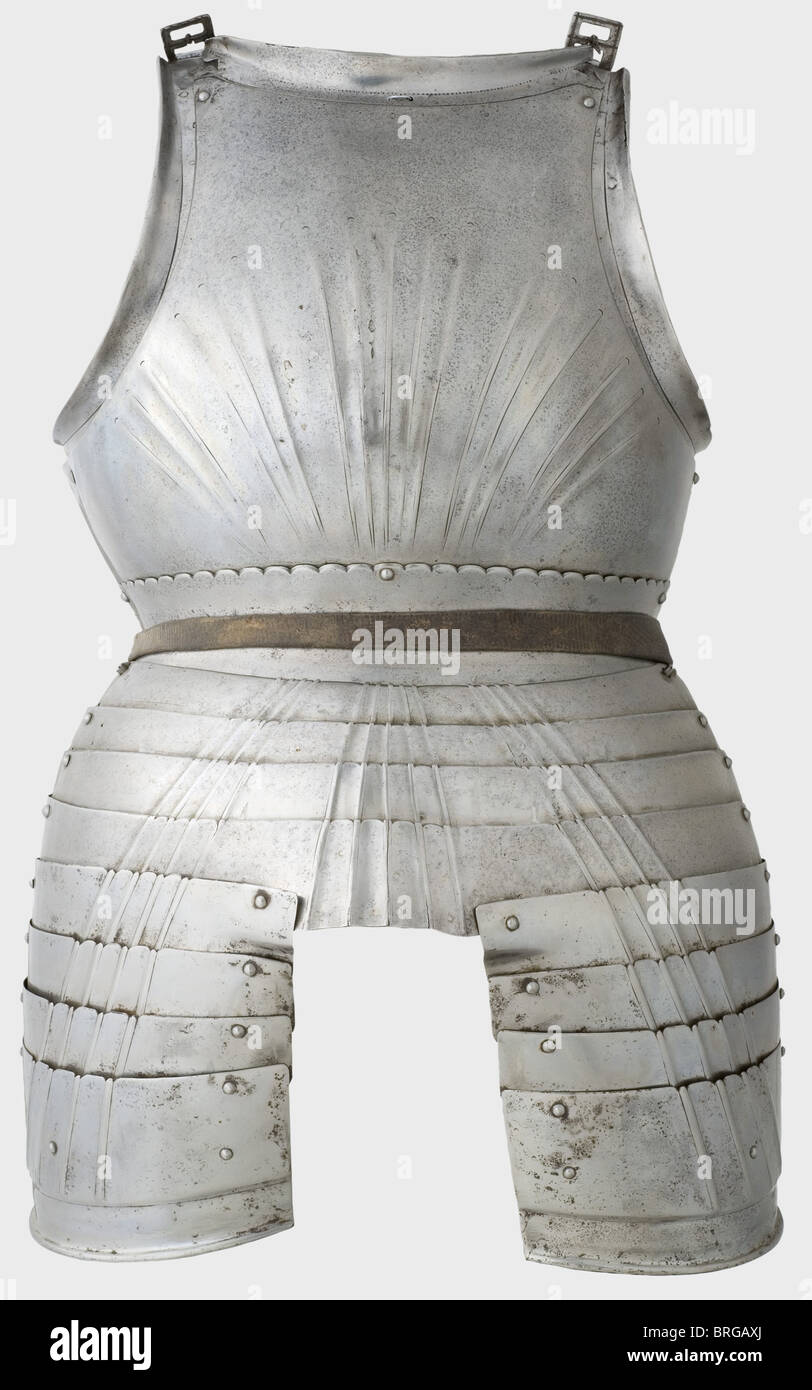 A Maximilian breastplate,Southern German,circa 1510 Strongly cambered,fluted breastplate with a riveted neckplate and stomach plate.The neck opening has a strong,edged flange above decoration that has been worn off in places by polishing.Movable laminated arm insets with heavy flanges and attached strap buckles.The buckle attachments have been restored.The stomach plate has a curved rim and four attached fluted taces.The top tace has a repair.Recently replaced tassets of four lames.Height 69 cm.Provenance: Howard M.Curtis Collection,auctioned by C,Additional-Rights-Clearences-Not Available Stock Photo