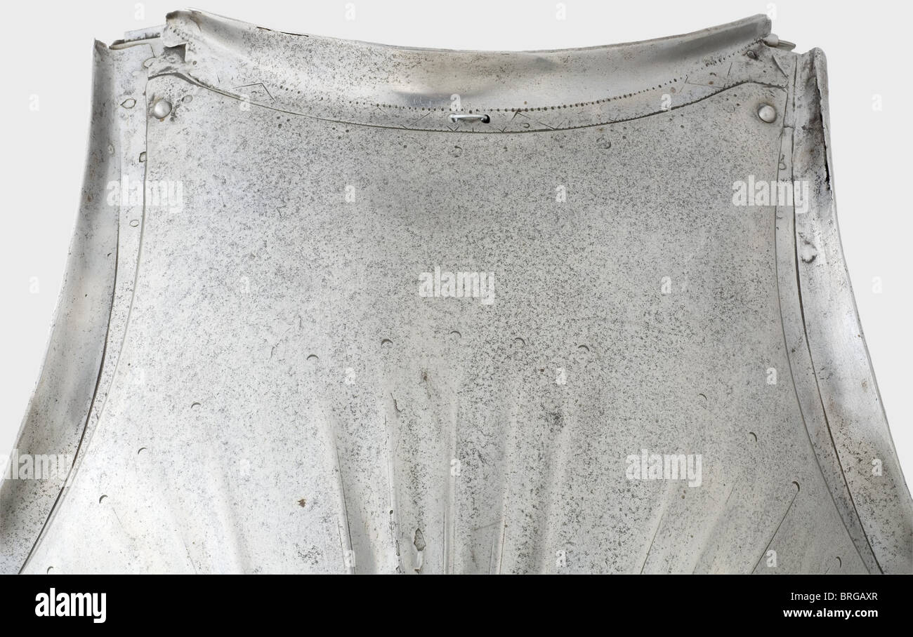 A Maximilian breastplate,Southern German,circa 1510 Strongly cambered,fluted breastplate with a riveted neckplate and stomach plate.The neck opening has a strong,edged flange above decoration that has been worn off in places by polishing.Movable laminated arm insets with heavy flanges and attached strap buckles.The buckle attachments have been restored.The stomach plate has a curved rim and four attached fluted taces.The top tace has a repair.Recently replaced tassets of four lames.Height 69 cm.Provenance: Howard M.Curtis Collection,auctioned by C,Additional-Rights-Clearences-Not Available Stock Photo