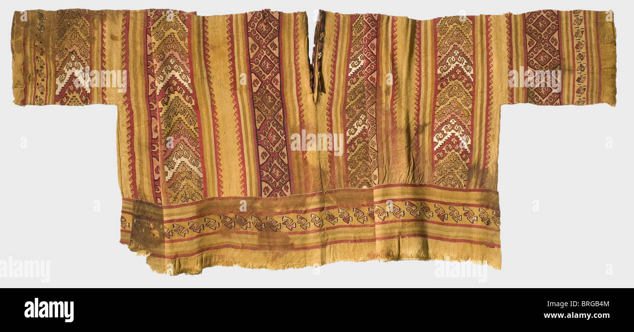 A mummy's shirt of the Chimu-Indians,Northern Peru,between 1250 - 1470 A.D. Broad cut with reinforced front and back placket and short sleeves. Multi-coloured,woven panels with geometric motifs in slit tapestry sewn together. In the broader stripes a repeated,stylised condor. Partly discoloured,the lower edge slightly damaged. Width with sleeves 141 cm,length 46 cm.,historic,historical,15th century,13th century,American,America,ethnology,ethnicity,ethnic,object,objects,clipping,cut out,cut-out,cut-outs,commodity,commodities,utensil,uten,Additional-Rights-Clearences-Not Available Stock Photo
