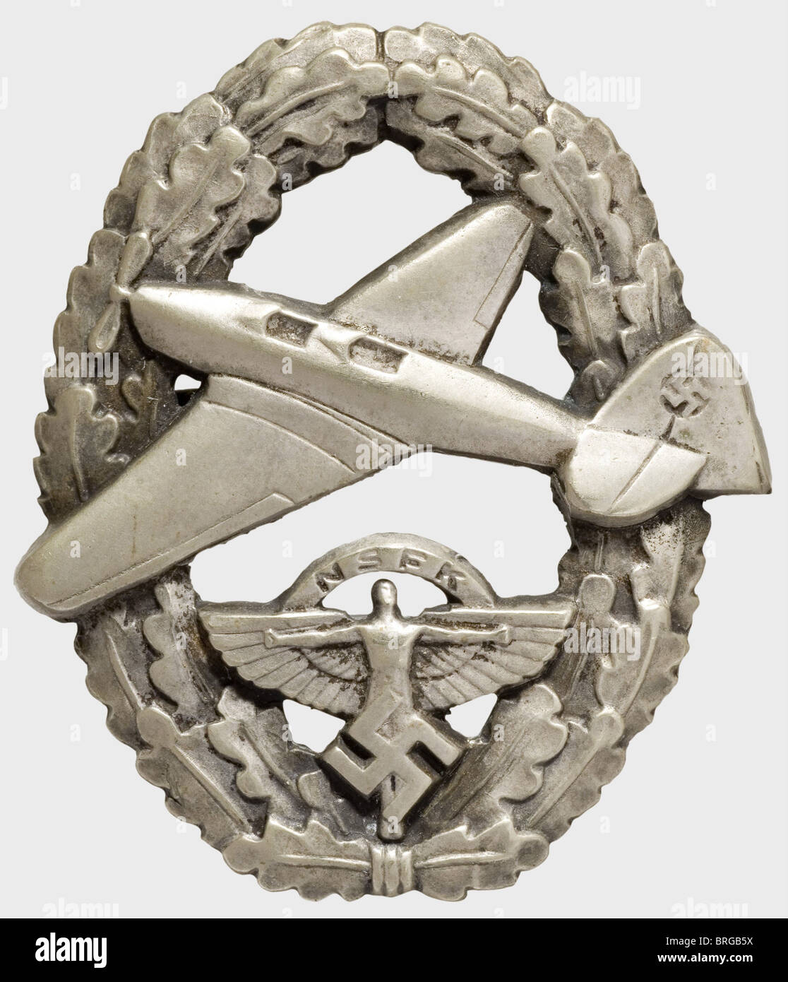 A NSFK Badge for Powered Aircraft Pilot,2nd issue after 1939 Silver-plated non-ferrous metal,hollow-stamped,the reverse marked 'Ges Gesch 22638',flat nickel silver pin attachment(OEK 3673). The badge introduced on 1 May 1939 superseded the earlier,silver-embroidered cloth issue badge and,as Christiansen wished,it bore the NSFK emblem instead of the swastika.,historic,historical,1930s,20th century,awards,award,German Reich,Third Reich,Nazi era,National Socialism,object,objects,stills,medal,decoration,medals,decorations,clipping,cut out,Additional-Rights-Clearences-Not Available Stock Photo