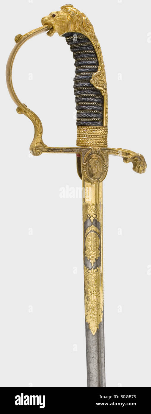 A lion's head sabre for Württemberg officers,in deluxe version Curved pipe-backed Damascus blade with yelmen,the upper quarter with gilt decorative etching,the Wuerttemberg coat of arms and a knight's head mark.Finely chiselled,fire-gilt knucklebow hilt.The lion's head pommel has inset red glass eyes,and the obverse languet bears the head of an ancient warrior.Sharkskin grip cover with wire winding.Iron scabbard with two movable brass suspension rings.The guard has been corrected and the riveting renewed.Light,elegant issue.Length 87 cm.,historic,,Additional-Rights-Clearences-Not Available Stock Photo