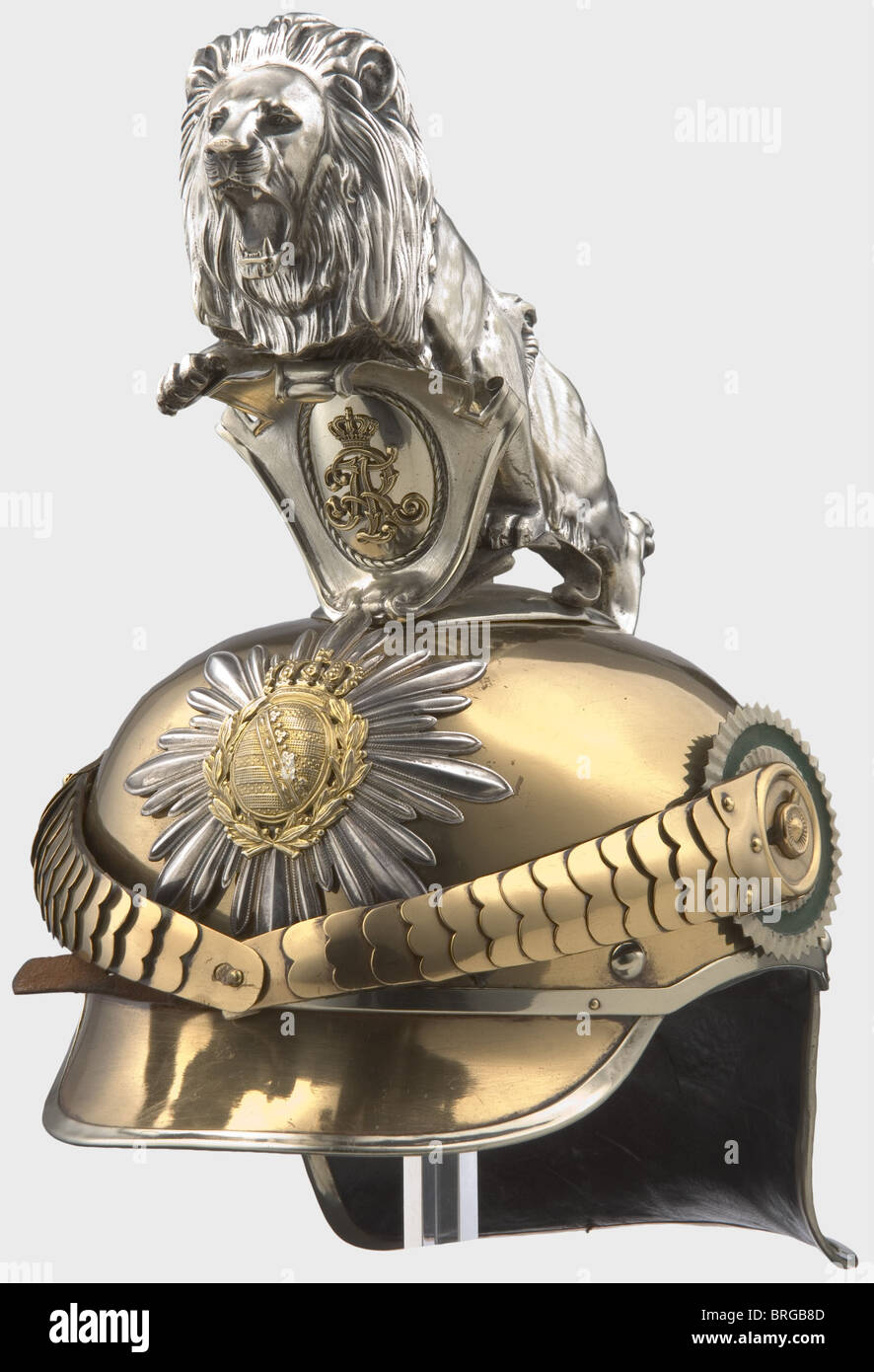 A model 1889/1907 helmet for enlisted men,of the Royal Saxon Gardereiter-Regiment Tombac skull,silver-plated star with superimposed coat of arms,convex metal chinscales on '91' button.Enlisted personnel cockades.Inside the maker's name 'G.H.Osang Dresden 1915',size '55',on top item number '34'.Black leather lining.The rear peak is covered with black leather,the front peak painted green on the inside.Silver-plated parade lion above the cipher shield.Rare helmet in beautiful condition,traces of mechanical cleaning on skull and lion.,historic,histo,Additional-Rights-Clearences-Not Available Stock Photo