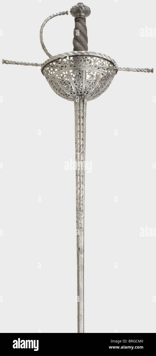 A cup-hilted rapier,Pedro de Velmonte,Toledo,circa 1670 A slender thrusting blade with fullers on both sides of the upper third bearing the stamped signature,'Pedro de Velmonte en Toledo'.The cup guard has openwork and cut vine decoration as well as a narrow,wavy flange.Blossom shaped and engraved 'guardapolvo'.Extended fluted quillons and knucklebow.Grip cover with possibly original,iron wire winding and braided ferrules.Fluted pommel.Length 114 cm.Pedro de Velmonte is entered in Francisco Palomares list of masters,Toledo 1762.His blades were so,Additional-Rights-Clearences-Not Available Stock Photo