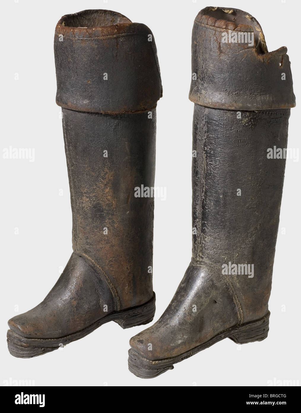 A pair of German or French cuirassier jackboots,17th century Heavy boots of hardened blackened leather. The feet have soles made up of several layers of nailed leather. Wide bootlegs with heavy sewn-on knee flaps(one flap damaged). One boot has retained the knee padding. Height of each 60 cm. Rare protective boots which were worn by armoured cavalrymen to protect their legs from slashing attacks.,historic,historical,,17th century,defensive arms,weapons,arms,weapon,arm,fighting device,object,objects,stills,clipping,clippings,cut out,cut-out,cu,Additional-Rights-Clearences-Not Available Stock Photo