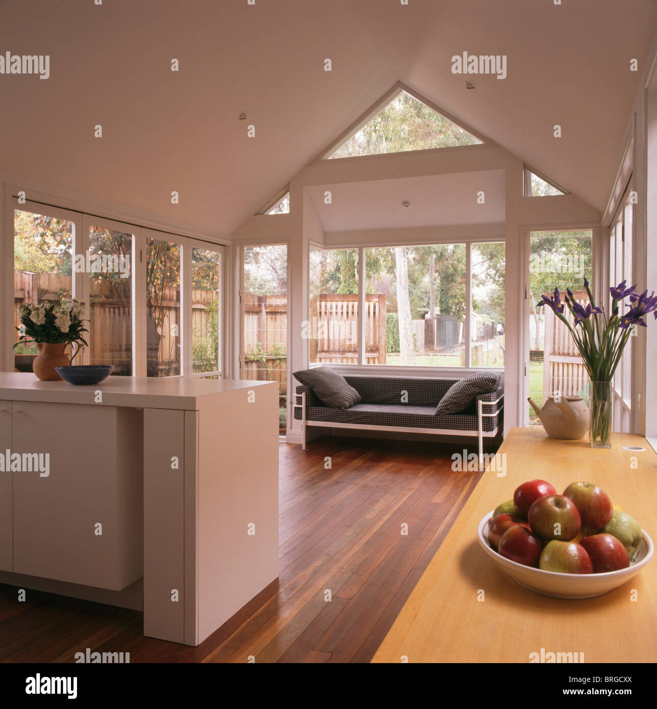 Modern White Open Plan Kitchen And Living Room Extension With Black And Chrome Sofa And Wooden Flooring Stock Photo Alamy