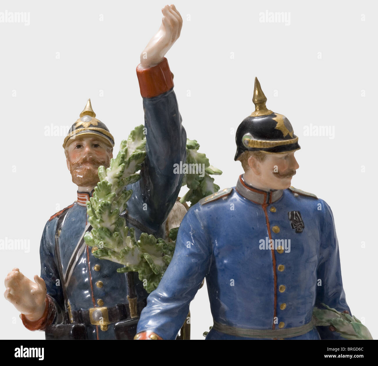 The Glorious Homecoming of the Victors 1871,a group of figurines manufactured by Meissen Porcelain,colour-composed,finely hand painted.Very detailed depiction of an officer of the Royal Saxon 1st Life Guard Grenadier Regiment No.100 and a grenadier of the 2nd Grenadier Regiment No.101 Kaiser Wilhelm decorated with laurel and oak leaf wreaths.The plinth adorned with roses and rocaille work,the base with swords mark in underglaze blue,a "P 183" scratch mark and press number "94".Height 27.5 cm.Very rare and in excellent condition.Cf.Hermann Historica,Additional-Rights-Clearences-Not Available Stock Photo