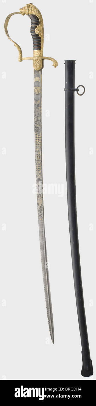 A splendid lion's head sabre,for an artillery officer,Baden High quality Damascus pipe-back blade with yelmen and lavishly etched with decorative floral and geometric designs.The gilding is worn in places.The obverse side shows the crowned Baden coat of arms in a sunburst.The reverse side bears the dedication cartouche,'Knettigen seinem lieben Laube'(Knettigen to his beloved Laube)as well as the monogram 'HL' in a sunburst.Gilded brass hilt(loose)richly decorated in relief.The lion's head has two red glass eyes.The knucklebow with an openwork flora,Additional-Rights-Clearences-Not Available Stock Photo