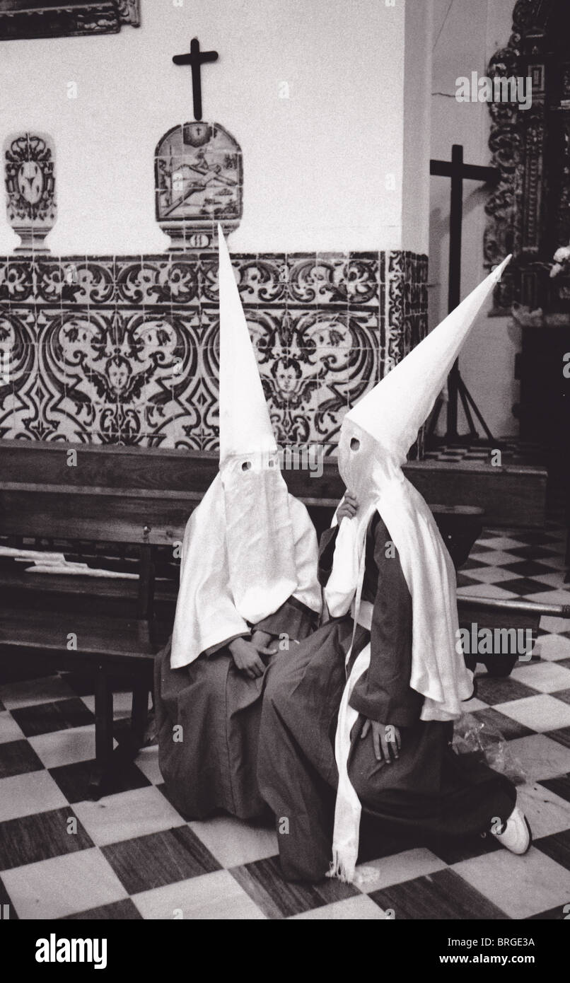 SPAIN MASKED CHILDREN CELEBRATE HOLY WEEK IN A CHURCH IN SEVILLE Stock Photo