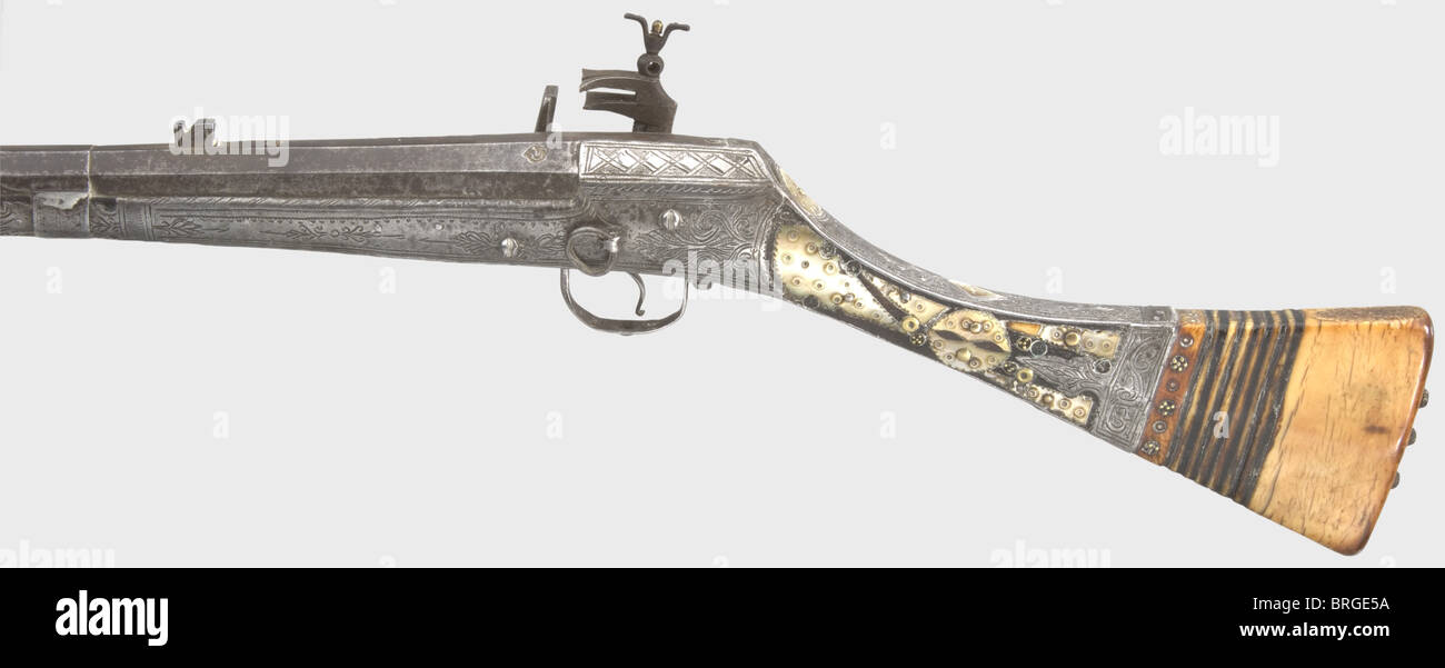 A miquelet flintlock rifle,Ottoman/Balkans,end of the 18th century  Octagonal barrel with a seven-groove rifled bore in 13 mm calibre with iron  rear sight. Two Arabic maker's marks are stamped above the chamber.