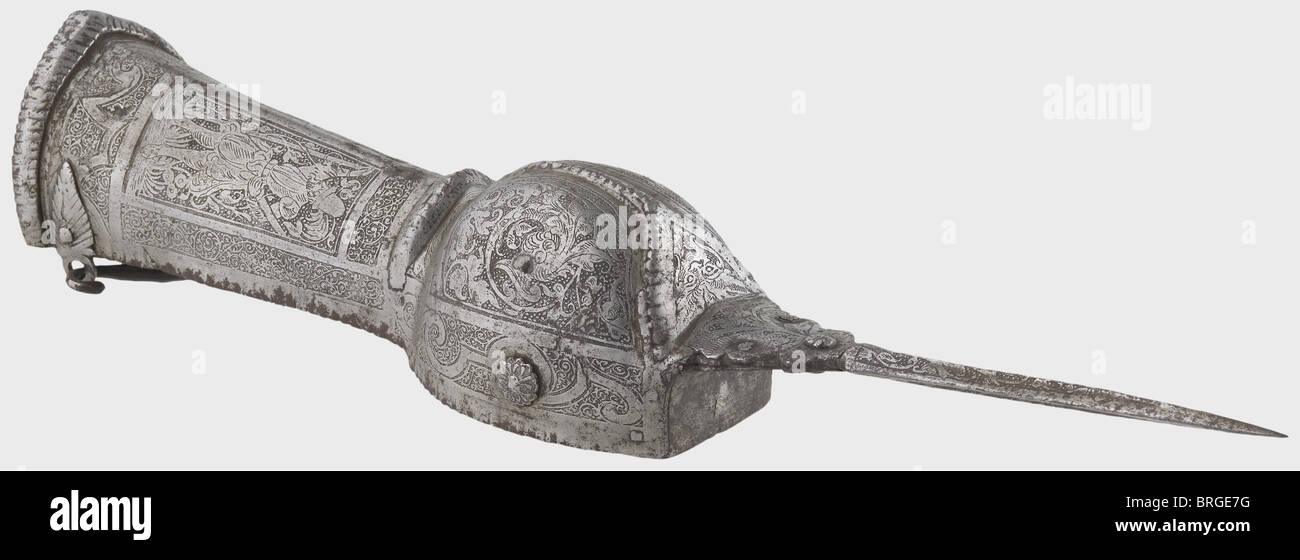 An Indian pata with European etchings,India/Brunswick,circa 1580 The iron hand guard elaborately forged and decorated with strong ridges,roped edges. Laterally riveted grip and movable wrist clasp. The square thrusting blade fixed to the guard and fully etched by Brunswick artists with a lansquenet scene amidst tendrils. Old inventory number. Length 57 cm. Extremely rare Indian pata,decorated in Brunswick,circa 1580. Provenance: Ducal Hanovarian collections,Marienburg Castle.,historic,historical,16th century,dagger,daggers,thrusting,thrustings,bat,Additional-Rights-Clearences-Not Available Stock Photo