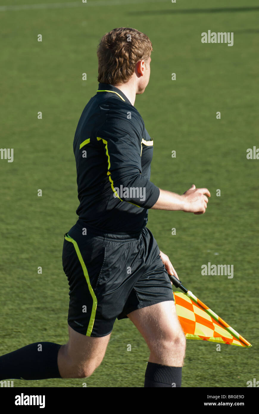 Side referee running along of the pitch border Stock Photo Alamy