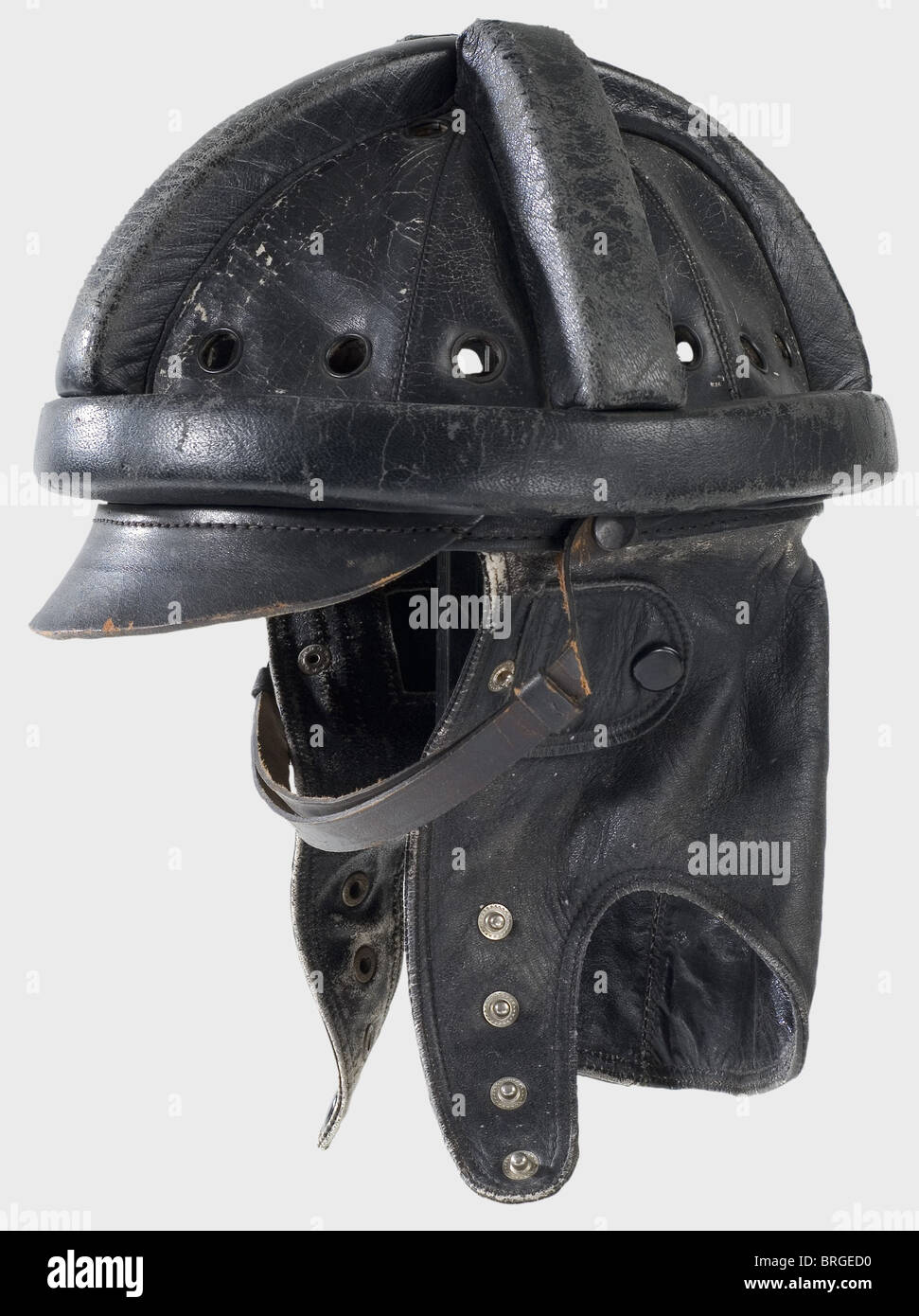 A protective leather helmet,for a transport-glider pilot Black leather  skull with cross-shaped protective comb and surrounding protective padding  roll.Four large air holes in each segment between the cross branches of the  comb.Leather