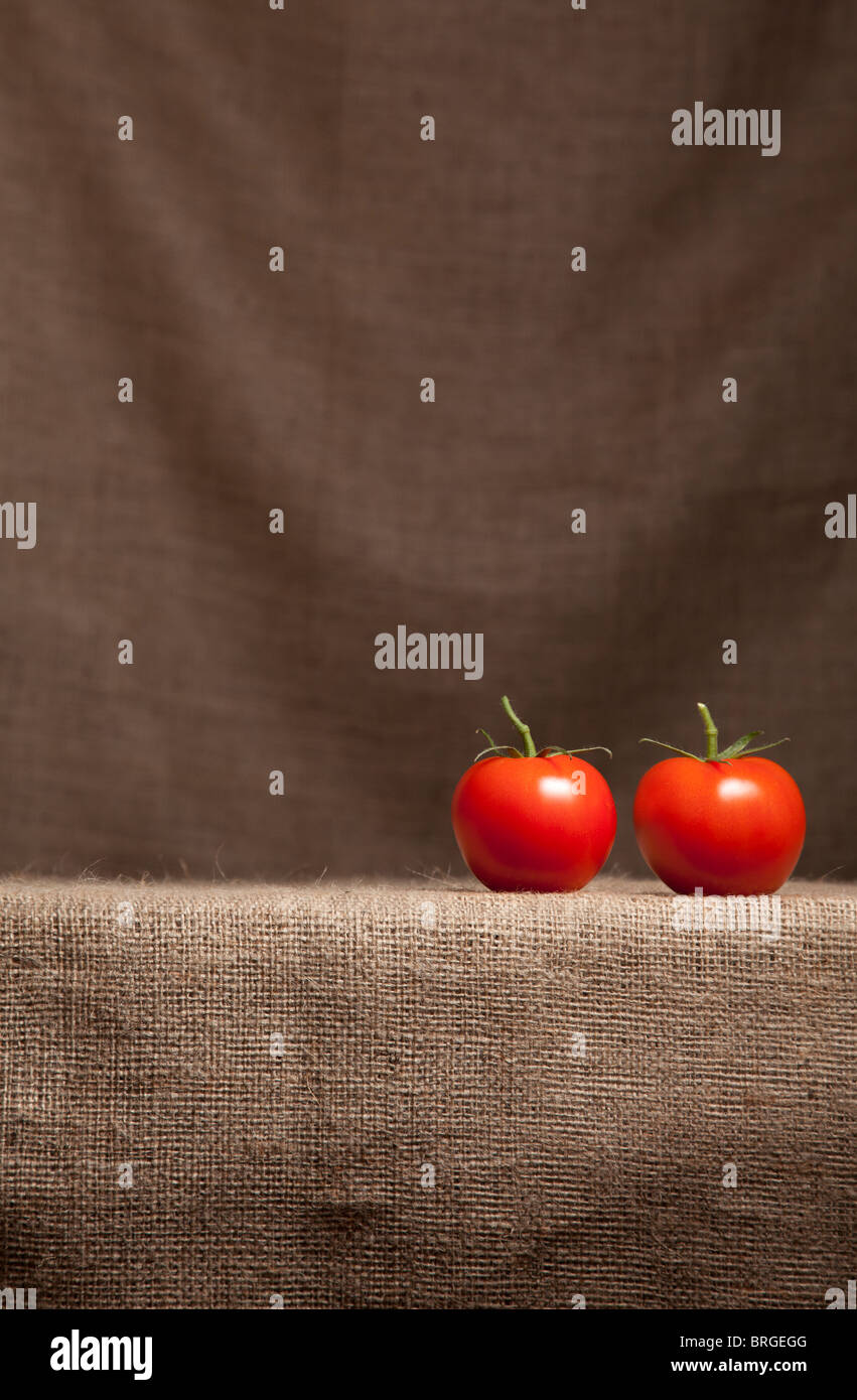Tomatoes resting on farmer's Hessian (burlap) cloth Stock Photo