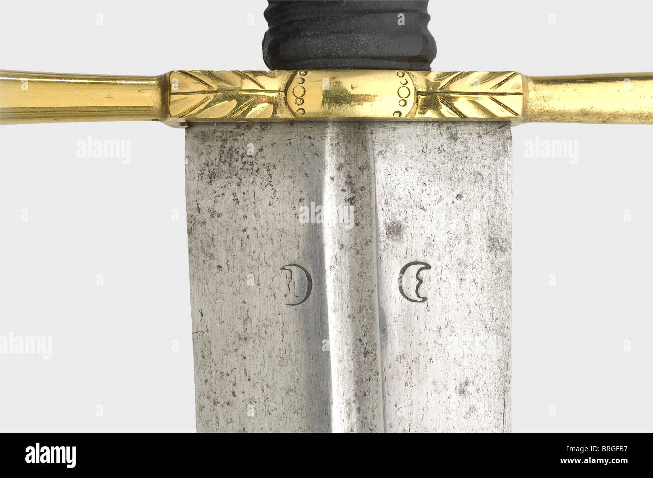 A German executioner's sword,circa 1700 Broad double-edged blade with a rounded point. Narrow fullers on the upper half,and a crescent moon mark stamped on both sides at the base of the blade. Brass quillons with chased decoration. Replacement leather grip cover. Faceted brass pommel,the upper half is fluted and has chased ornamentation. Length 112 cm.,historic,historical,18th century,instrument of torture,torture device,instruments of torture,torture devices,object,objects,stills,clipping,clippings,cut out,cut-out,cut-outs,thrusting,thrusti,Additional-Rights-Clearences-Not Available Stock Photo