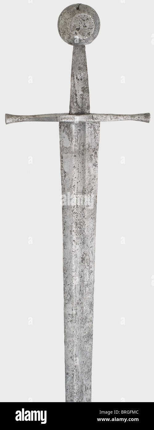 A Northern German knightly sword,circa 1300 Heavy,double-edged blade,slightly cracked near the point. The upper two-thirds have narrow fullers and indented St. Andrews' crosses and triple lines decorating both sides at the base of the blade. Straight quillons with lightly tapered reinforced finials. Broad tang. Disk pommel with bevelled edges. Cleaned excavation discovery. Length 104 cm.,historic,historical,14th century,sword,swords,weapons,arms,weapon,arm,fighting device,military,militaria,object,objects,stills,clipping,clippings,cut out,,Additional-Rights-Clearences-Not Available Stock Photo