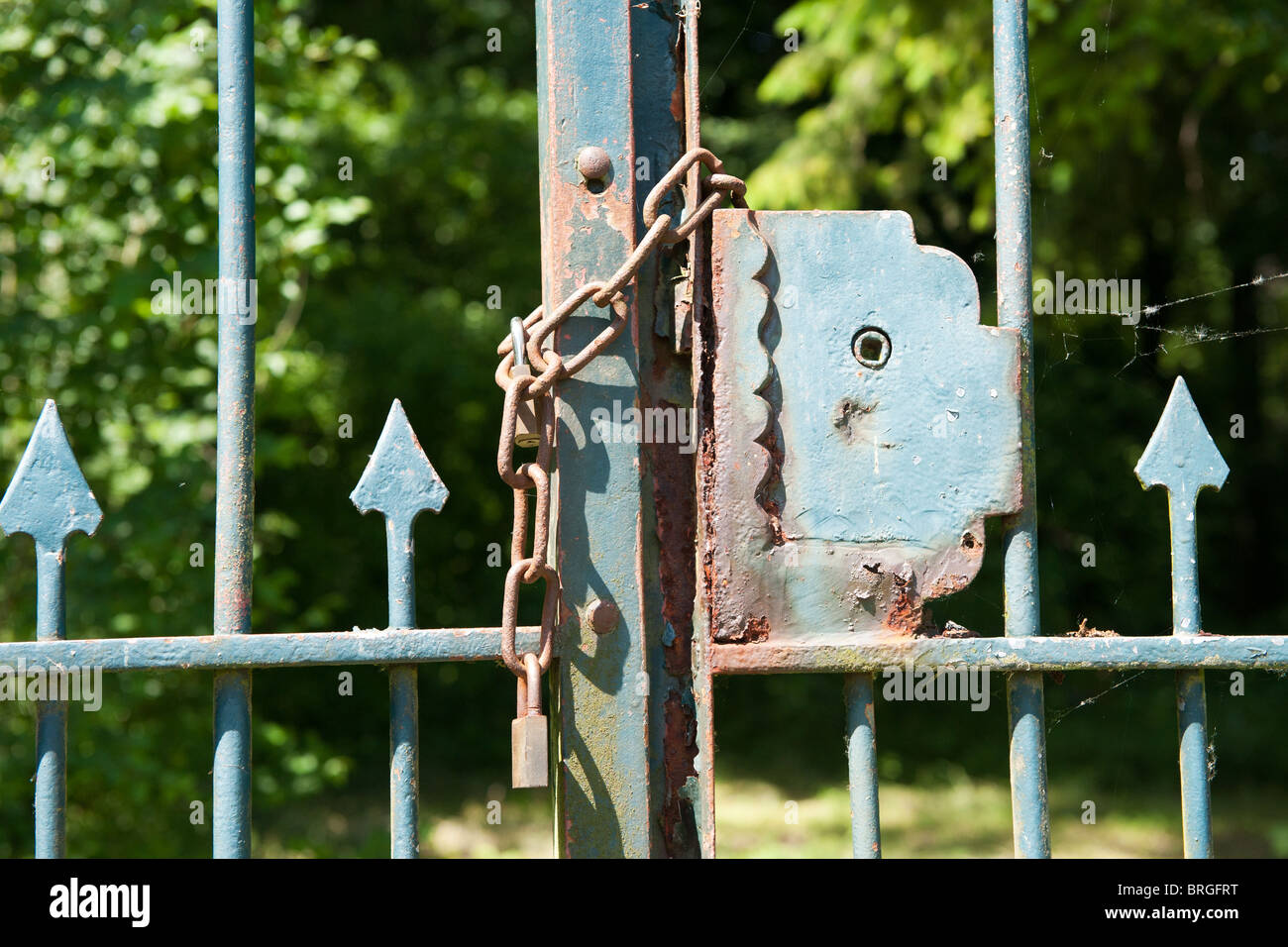 closed and locked rusty metal old fence Stock Photo