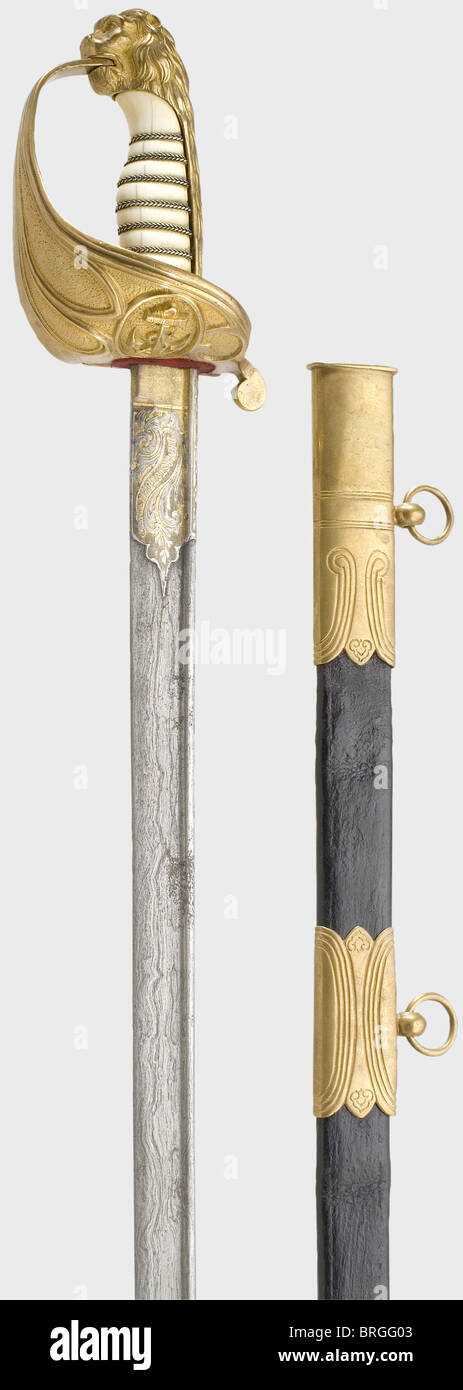 A lion head sword with ivory grip and Damascus blade,for officers of the Prussian Navy 1848 - 1866 Straight,Damascus pipe-back blade(somewhat stained)with a double-edged point. With inscription,"Eisenhauer - Damaststahl" surrounded by floral decoration on the gilded ricasso. Gilded lion head hilt with a fouled anchor on the obverse guard plate. Folding guard plate on the reverse side. Ivory grip(old crack)with silver wire winding. Black leather scabbard(dented in places)with three brass mountings. Length 90 cm. This sword version is very rare.,histori,Additional-Rights-Clearences-Not Available Stock Photo