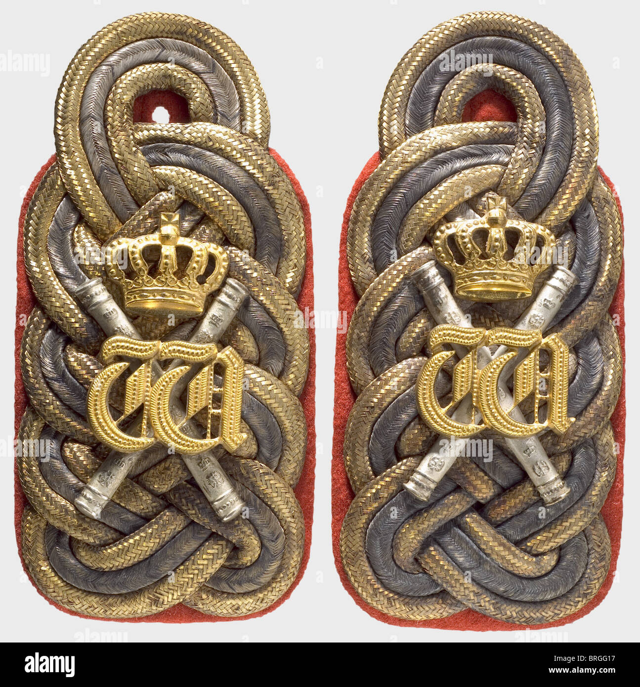 Kaiser Wilhelm II,model 1915 shoulder boards for his uniform as proprietor of the Hussar Life Guard Regiment Bright red cloth backing with a tongue to accept a sleeve.Braid from one silver and two golden flat cords,bearing silver marshal's batons below the gilded crowned cipher of Wilhelm I,which Wilhelm II wore as former adjutant to his grandfather.The braid is darkened in places.The shoulder boards come from the contents of the house at Doorn.See the exhibition catalogue for 'Der letzte Kaiser,Wilhelm II.im Exil',DHM 1991,ill.p.340,Ser.No.607b,Additional-Rights-Clearences-Not Available Stock Photo