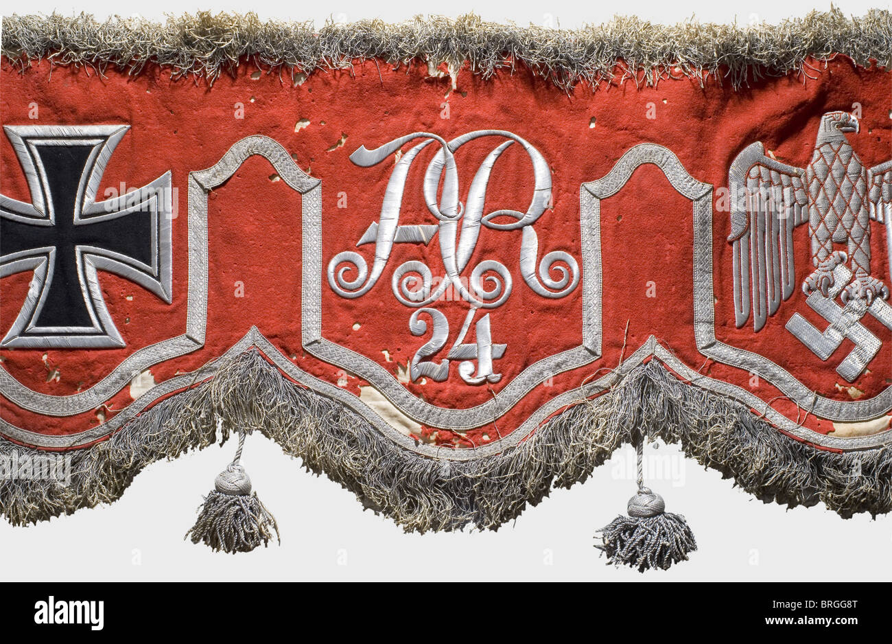 A model 1937 drum banner for the right kettle drum,of the 24th Artillery Regiment Red cloth with thick silver fringe above and below.The five fields are separated by silver lace,and embroidered in silver.Two bear the Wehrmacht eagle,two the iron cross,and one the regimental cipher 'AR 24'.(The left drum cloth would start with the iron cross.)Field grey lining on the back.Heavy moth damage,some fastening loops missing.The 24th Artillery Regiment was established in 1935 in Altenburg and assigned to the 24th Infantry Division.It participated in the fig,Additional-Rights-Clearences-Not Available Stock Photo