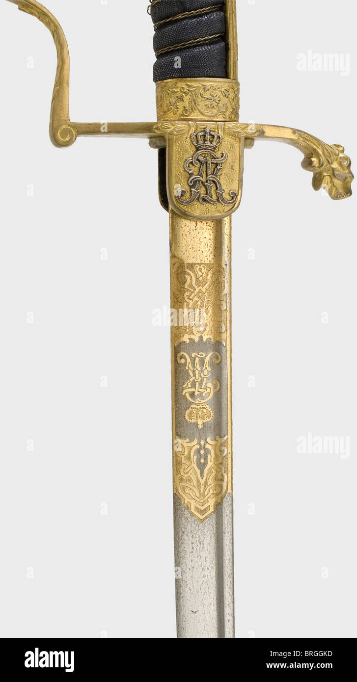 A lion's head sabre for officers,of the Saxon cavalry Slightly curved,pipe-backed Damascus steel blade with a yelmen. Richly etched and gilded on the ricasso,the obverse side bearing the crowned "FAR" cipher,the reverse side with the royal Saxon coat of arms. Gilded,sculpted brass knucklebow hilt. The obverse languet bears the silver "FAR" cipher under a crown. Sharkskin grip cover with damaged wire winding. Lacquered iron scabbard with a movable suspension ring and a riding loop. Length 92 cm.,historic,historical,19th century,Saxony,Saxonia,Saxonian,Additional-Rights-Clearences-Not Available Stock Photo