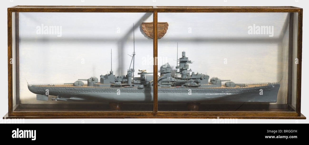 Fritz Wiedemann(1891 - 1970)- Hitler's personal adjutant,a model of the heavy cruiser 'Admiral Hipper',circa 1940 Detailed,wooden,not rigged full model with thick grey coloured paint,and planked upper deck.In a glazed showcase,the rear wall carved with a Reich's eagle with the name of the ship below.Length of the model 145 cm.Showcase dimensions 170 x 36 x 63 cm.There is also a folder from the Blohm & Voss Shipyard in Hamburg from 1940 with the plans for the electrical circuitry for the heavy cruiser's artillery.This model was presumably a gift to ,Additional-Rights-Clearences-Not Available Stock Photo