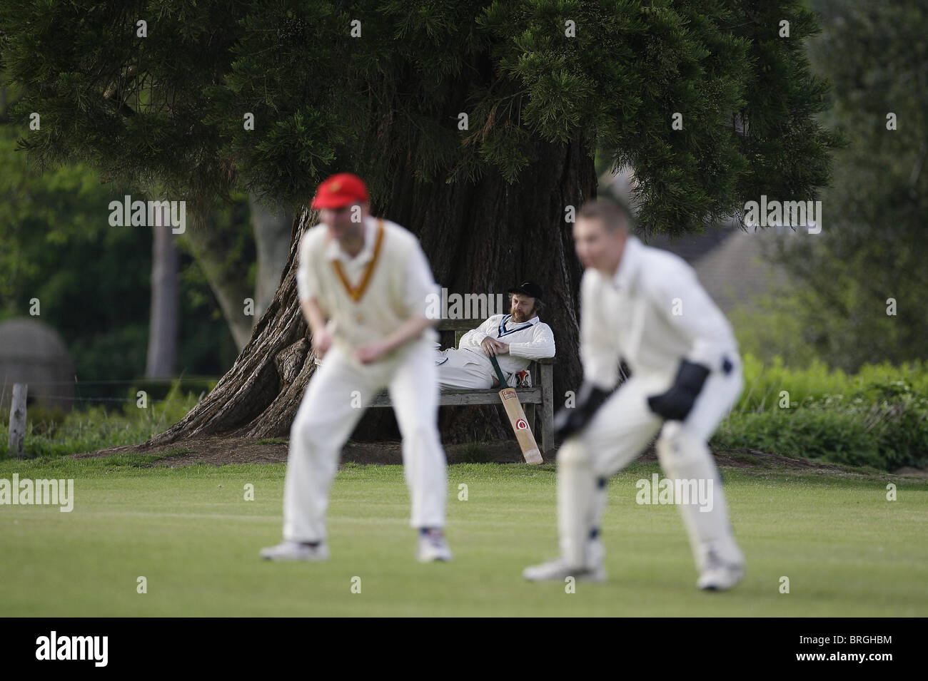 A Cricketer relaxes while watching a village match. Picture by James Boardman. Stock Photo