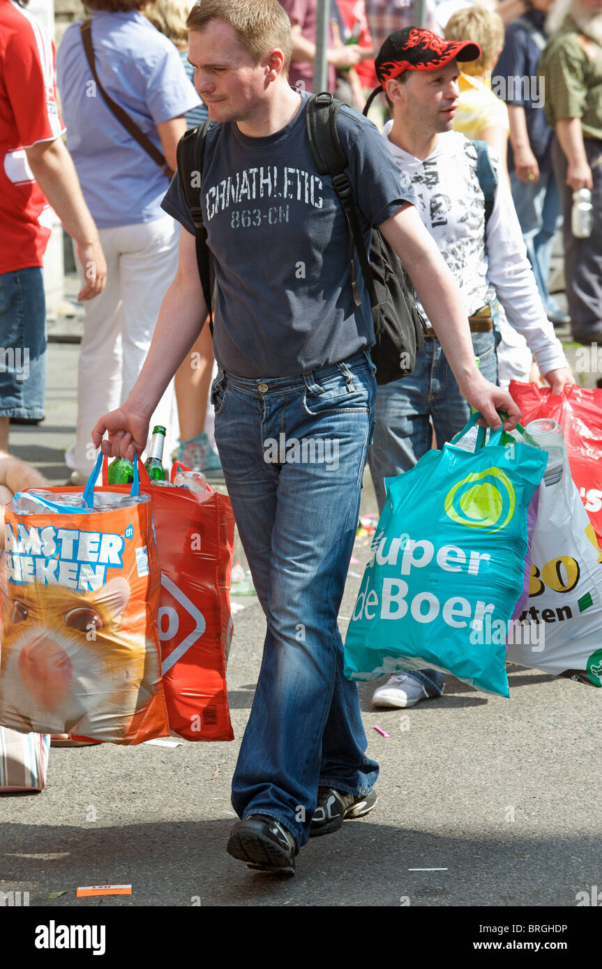 Jobless men collecting glass bottles after a street fair, Cologne ...